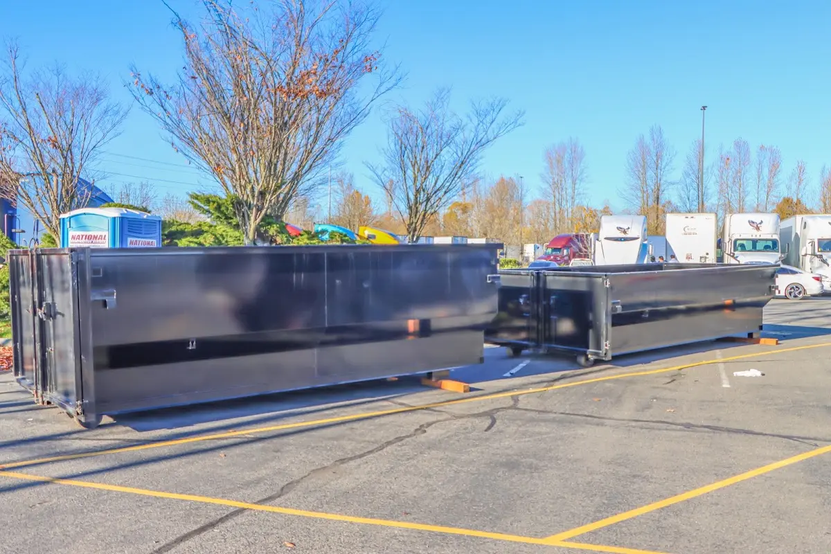 Professional dumpster rental service with roll-off container on residential driveway in La Junta